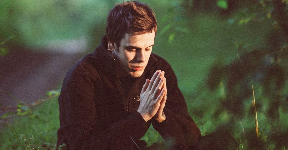 Man praying in the woods