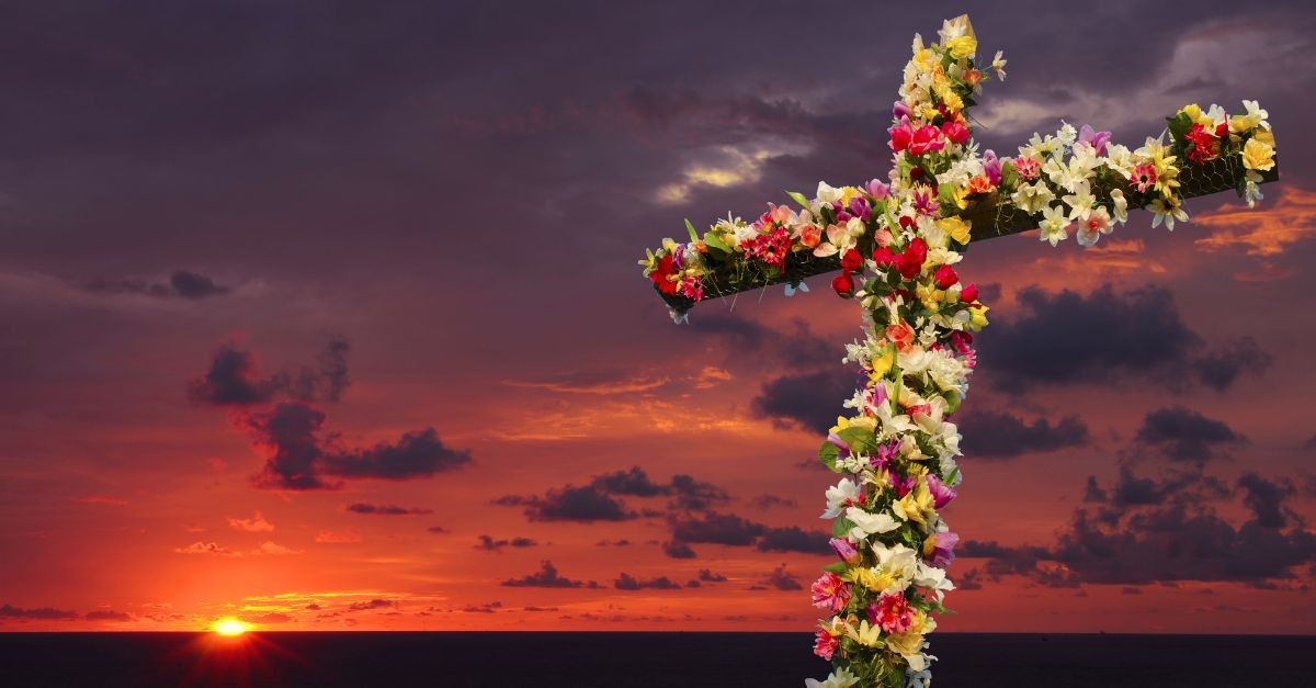 Flowered Cross decorated for a sunrise Easter service on the beach.