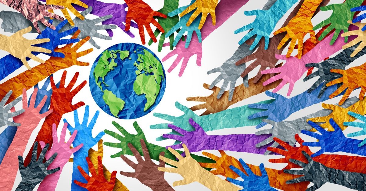 Different colored hands reaching towards the globe; praying for your home country.