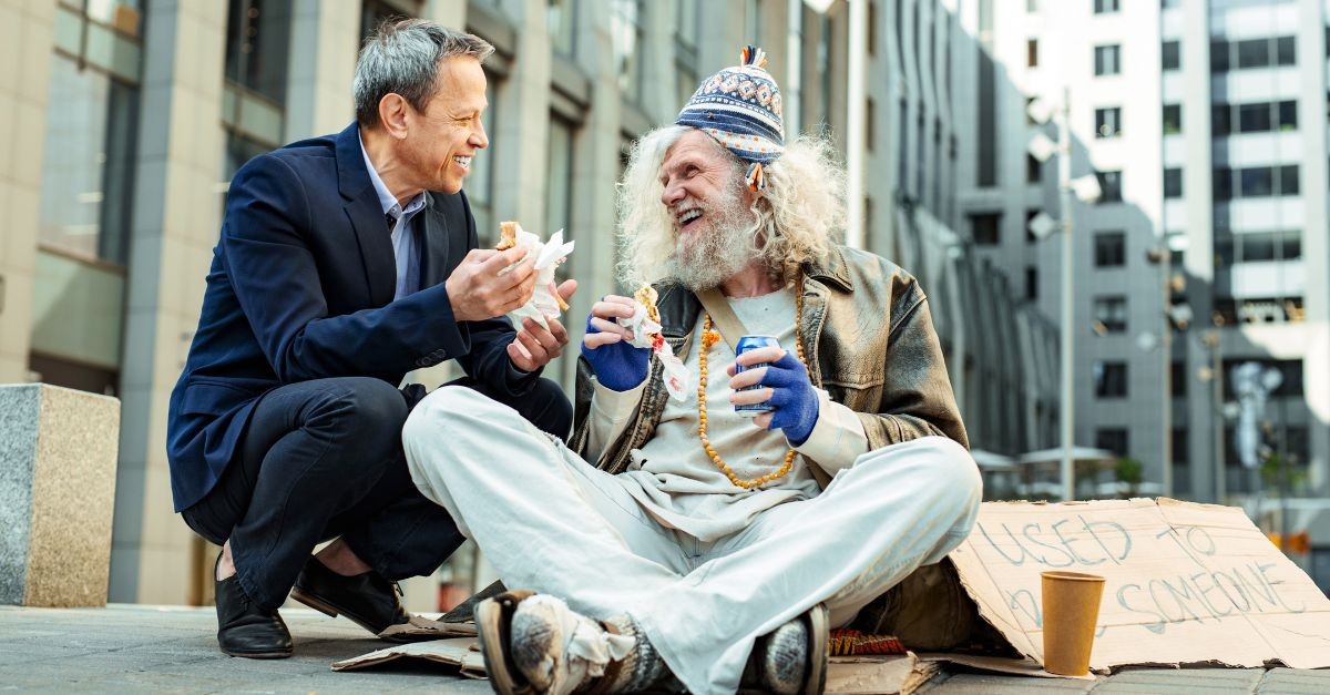 Business man stopping to help a homeless man; the difference between knowing about Jesus and knowing Him personally.