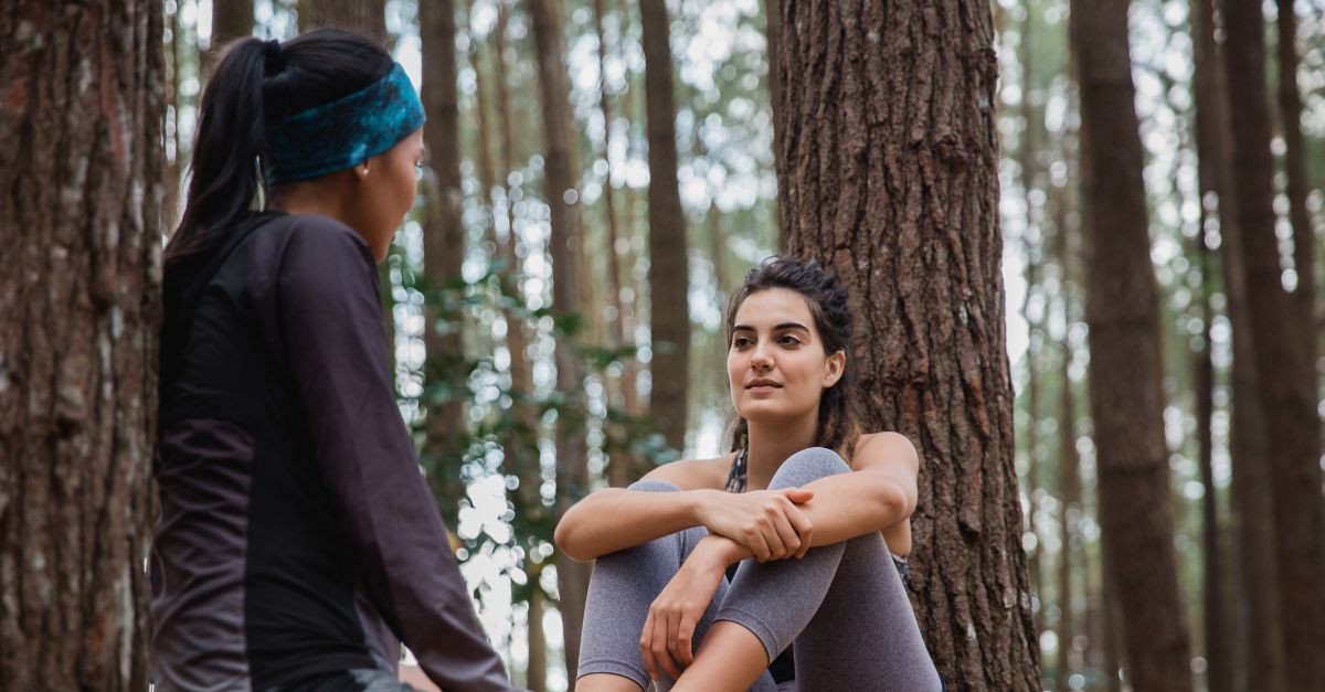 Women stopped in the woods to talk during a hike