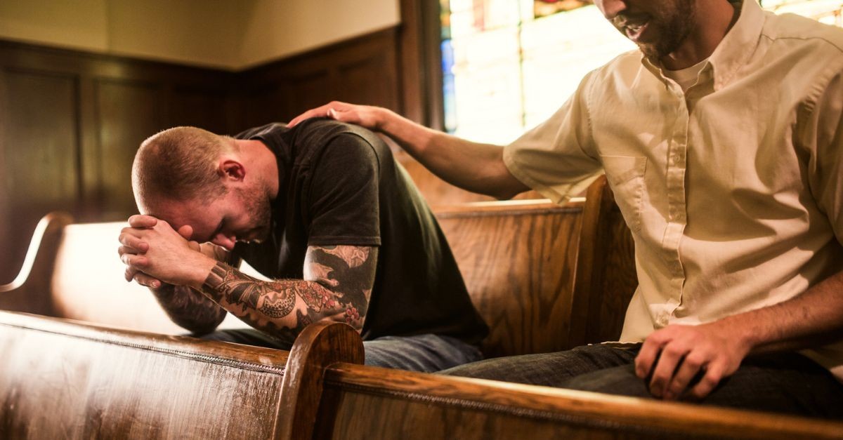 Men praying together; remembering God is in control; how can I help someone with anxiety?