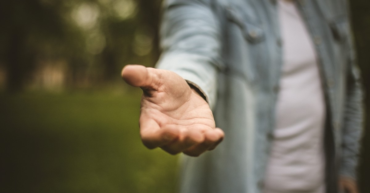 man holding out hand to help