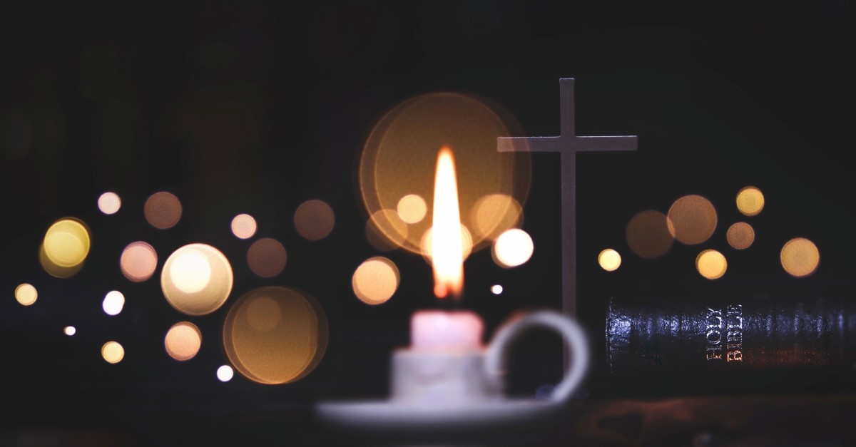 bible and cross with dark background to represent evening church services