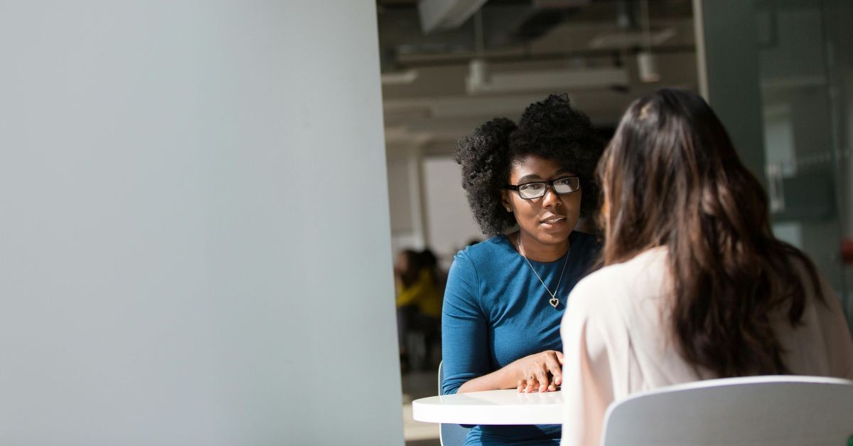 Two women sitting across from each other talking; the consequences of taking bad advice.