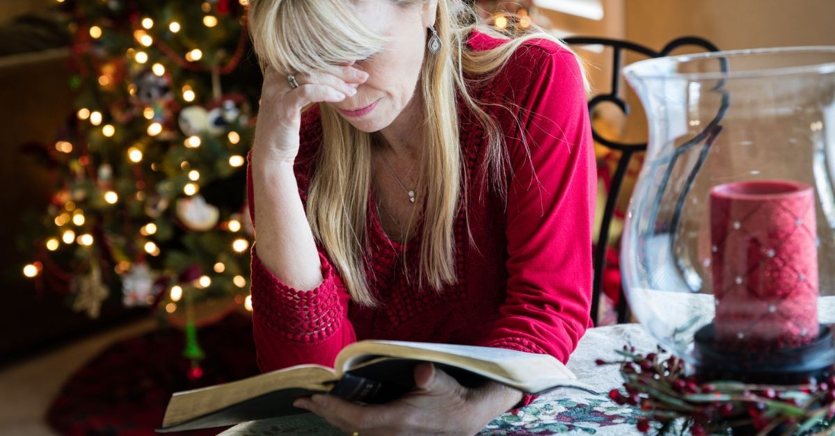 Woman Reading the Bible at Christmas