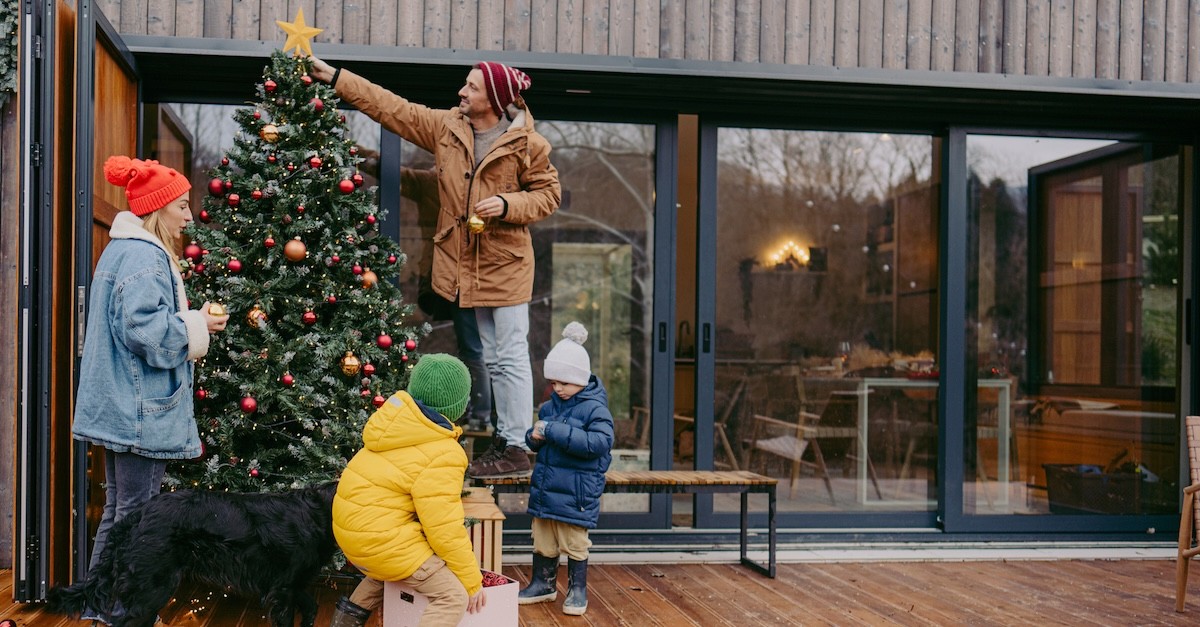 Family decorating Christmas tree ornaments