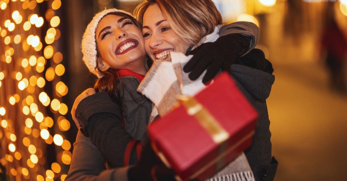 Two women hugging at Christmas; what does God want from us this Christmas?