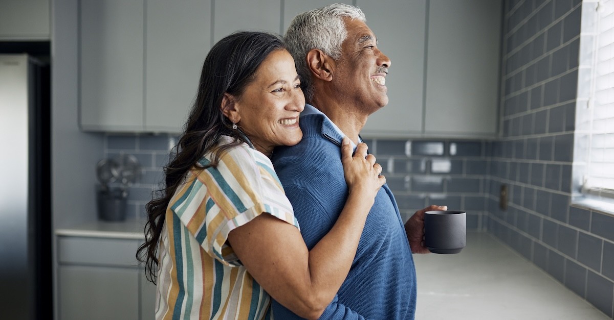 Happy older senior married couple in kitchen