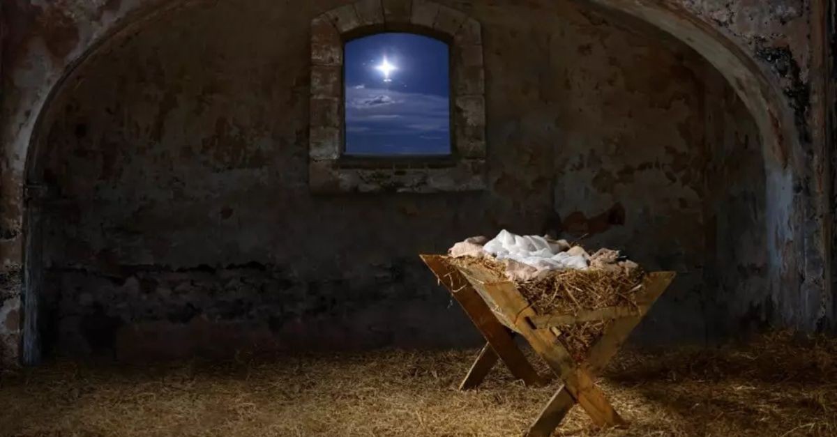 Manger in a stable, with the star of Bethlehem visible out a window