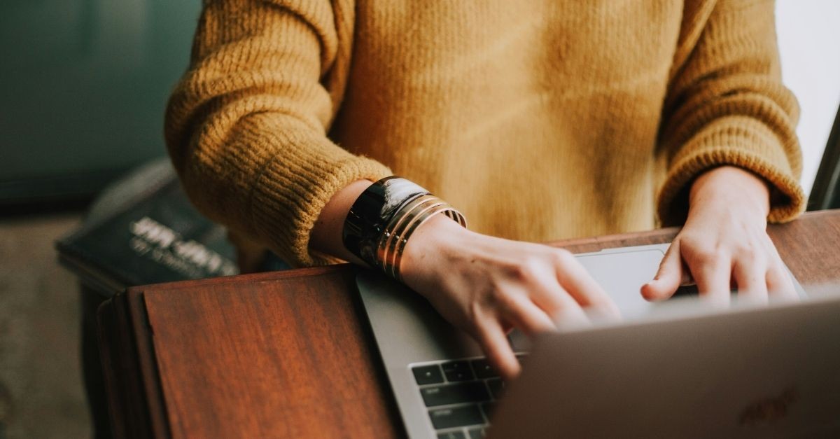 Woman on a laptop; what information overload is doing to your spiritual life.