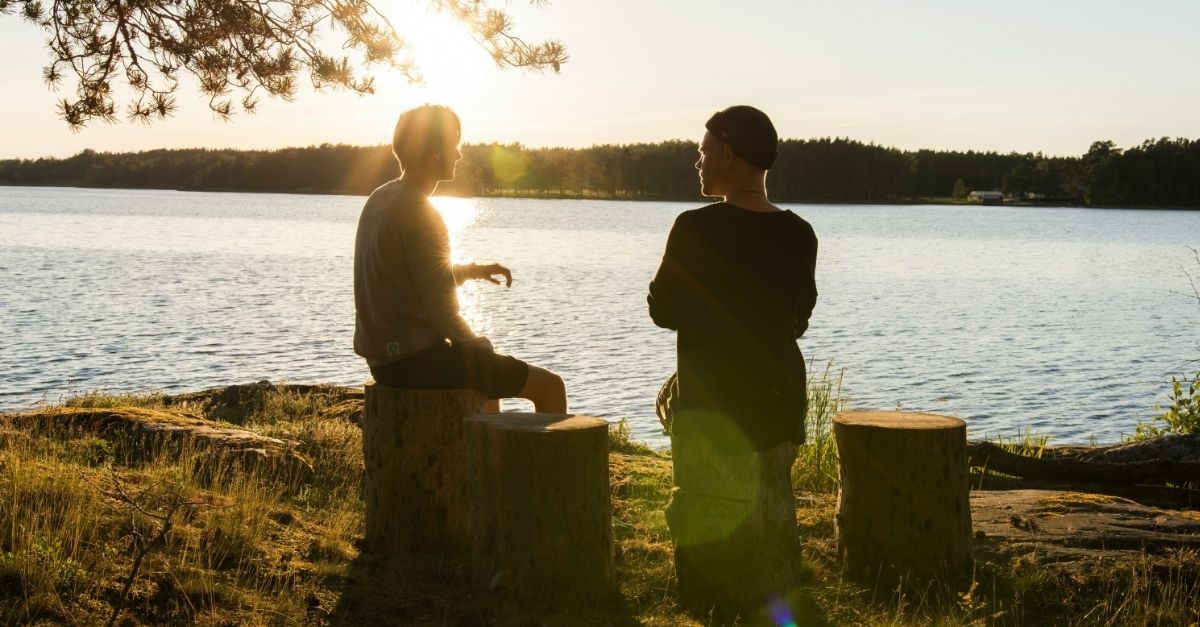 Two friends chatting by a lake; what does it look like to be a spiritual mentor?