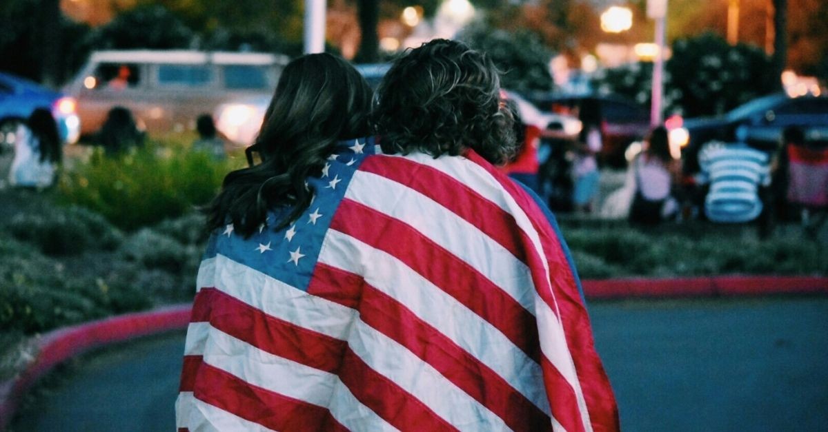 People Wrapped in an American Flag