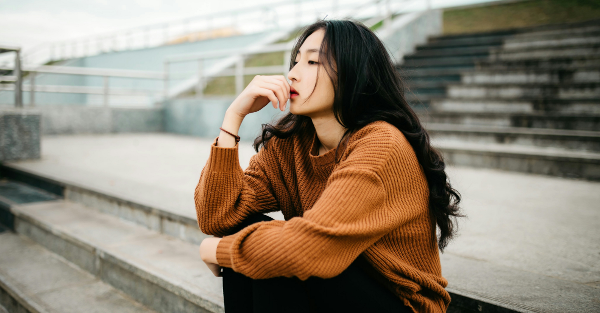 Woman Sitting on Bleachers, Thinking