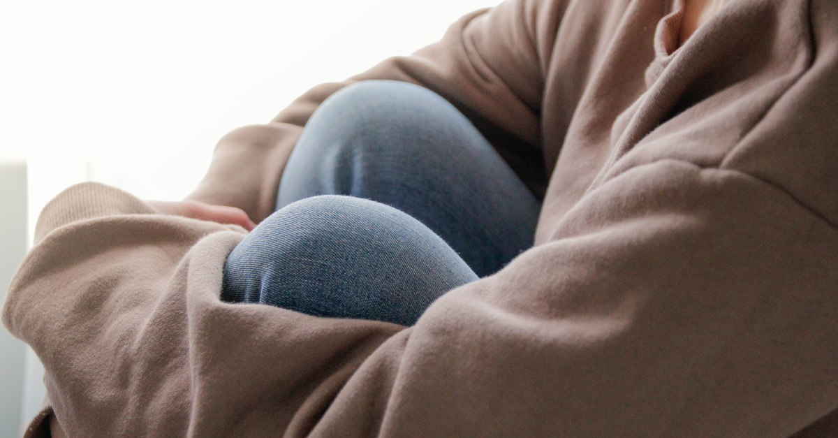 Woman sitting alone sad but hopeful