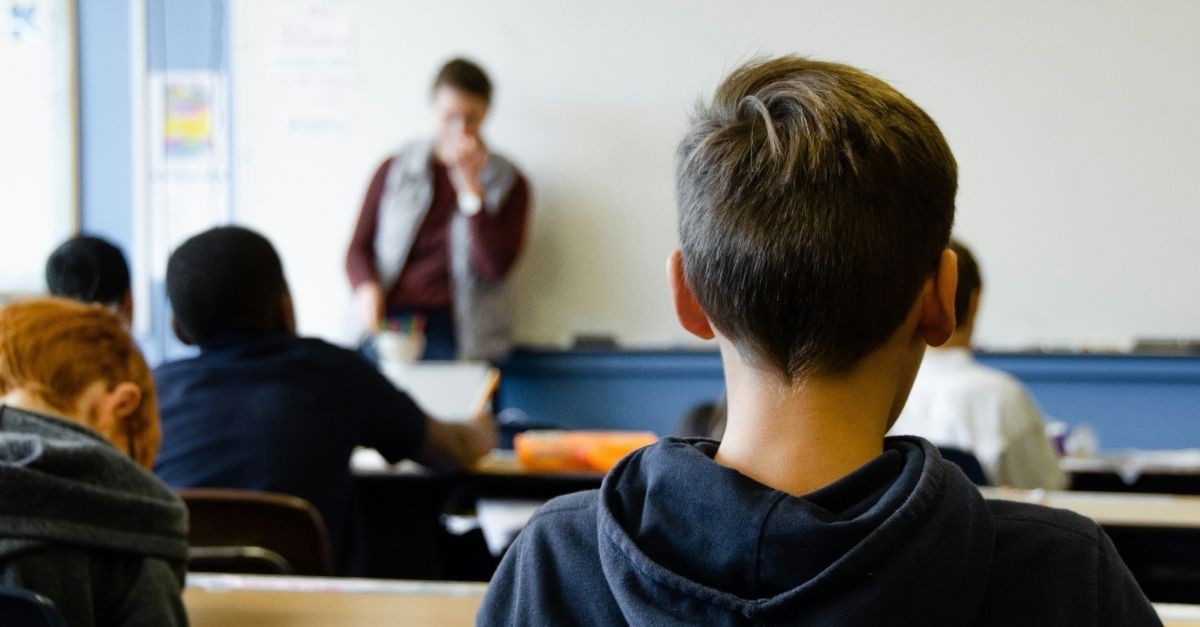 Kids in a classroom listening to their teacher; prayers for when your kids are at school