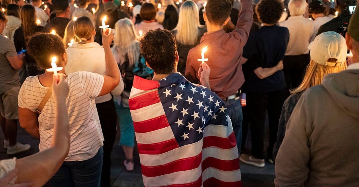America; American flag; memorial; praying; candle-lit memorial service for Charlie Kirk