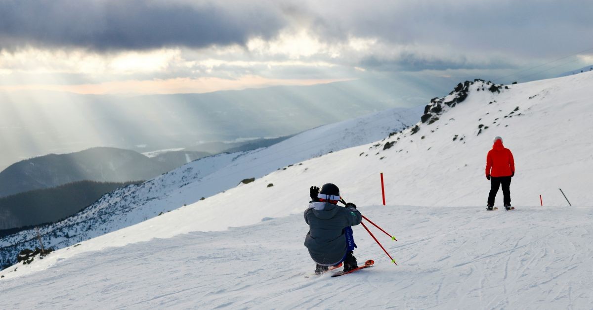 Downhill Skiers Skiing Down a Mountain