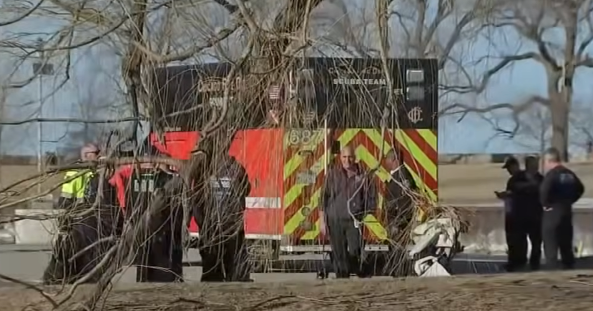 emts surrounding a stroller by a lake