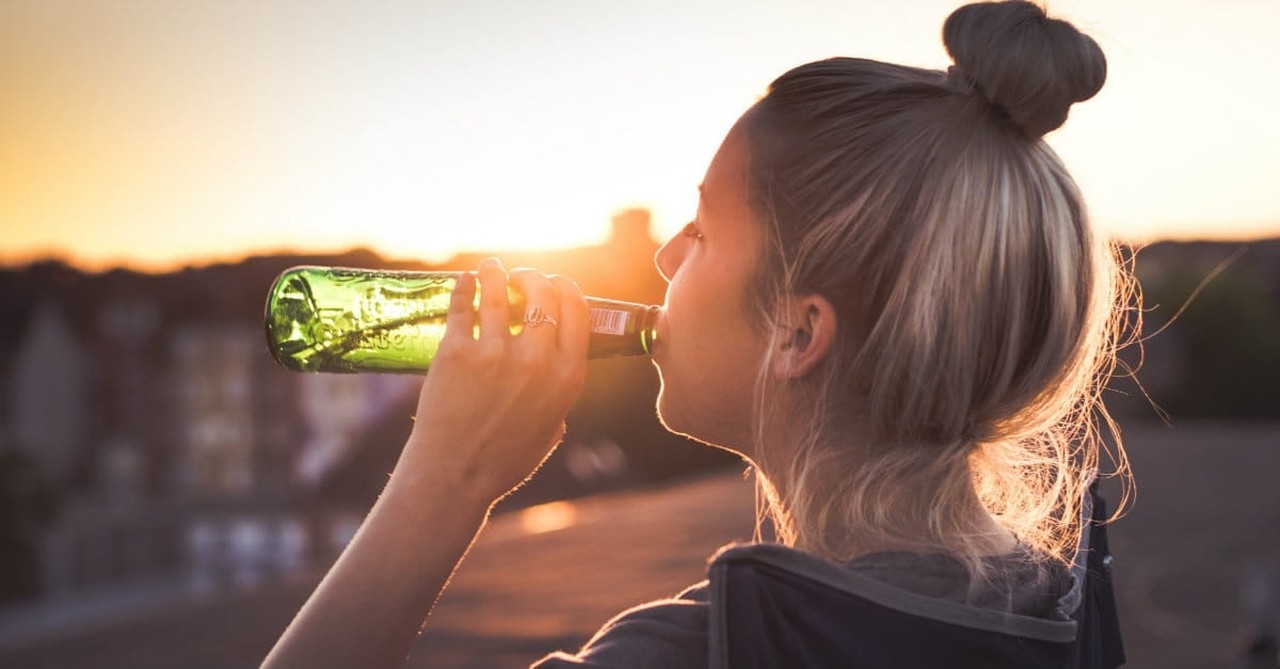 woman drinking from bottle