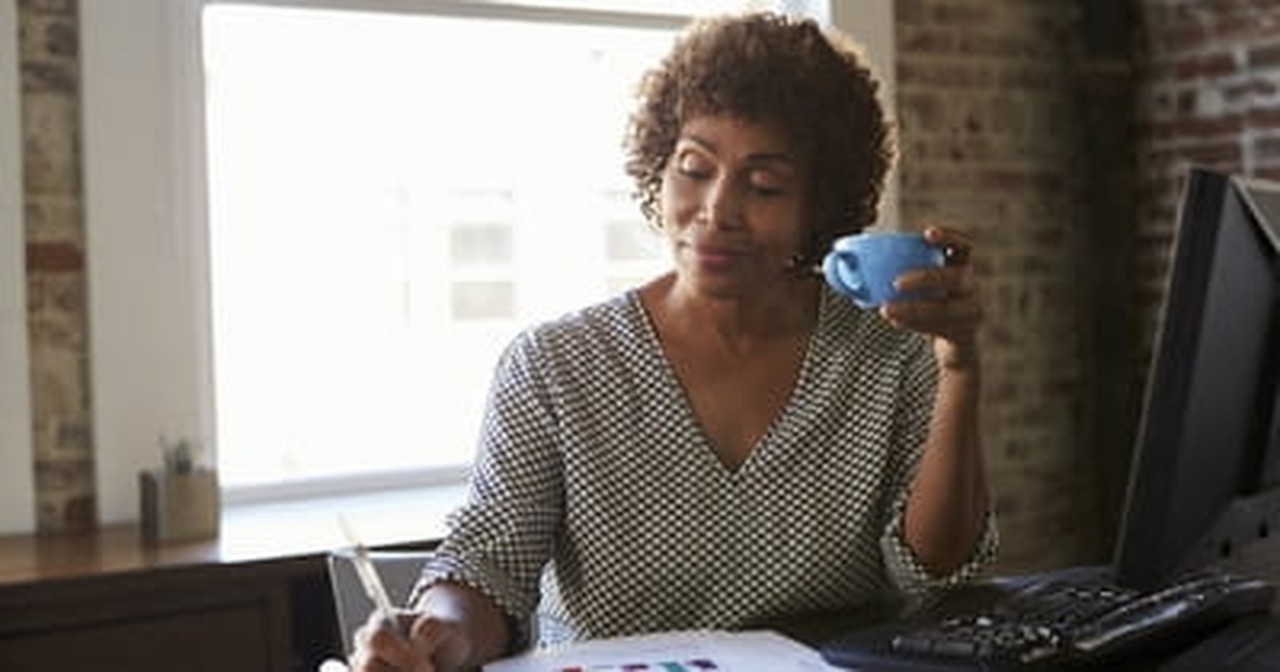 mature woman working on paper work and finances 