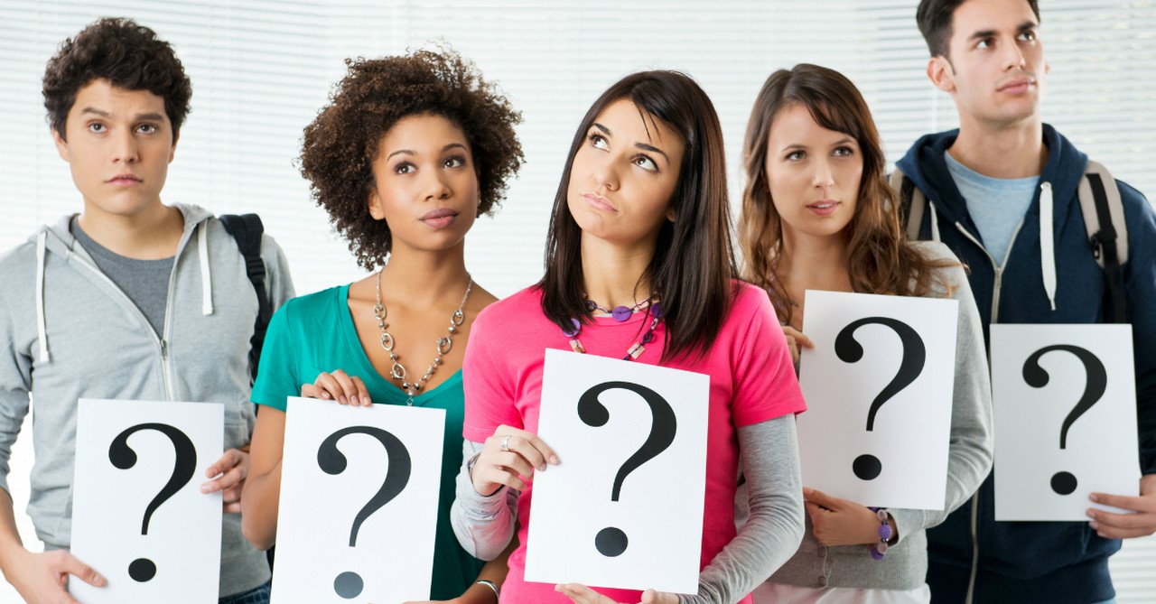 Group of confused people holding question marks