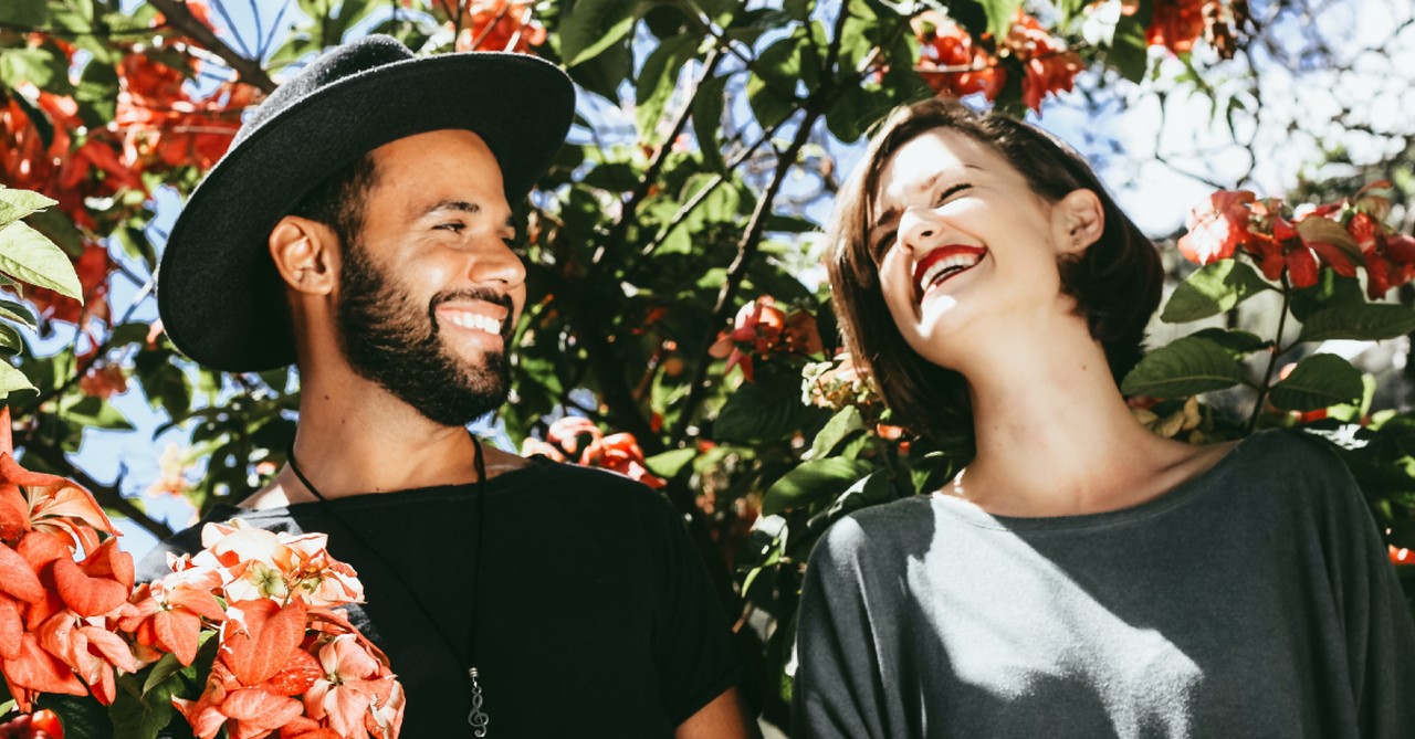 happy couple under flowers