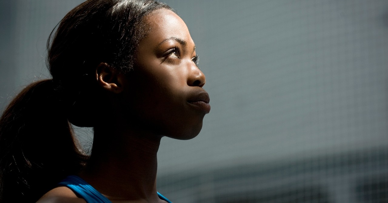 young woman looking up determined and serious