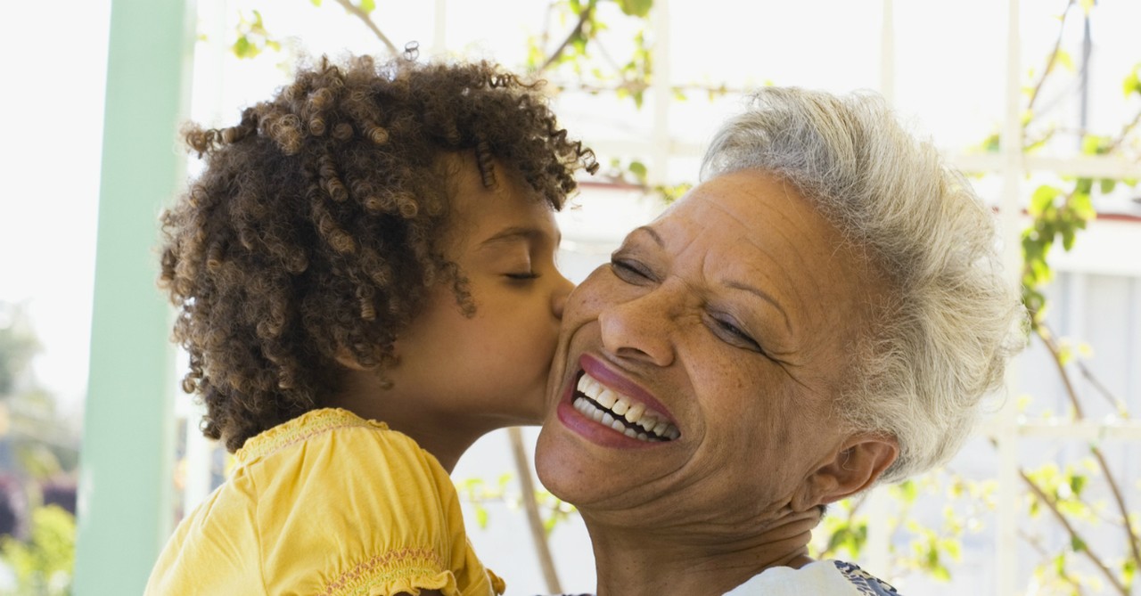 granddaughter kissing grandmother