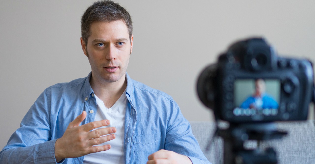 man talking into videocamera online church