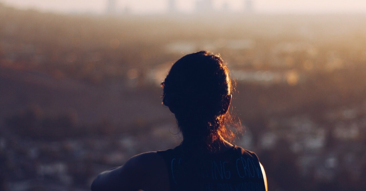 woman looking peaceful and confident sitting on a hill