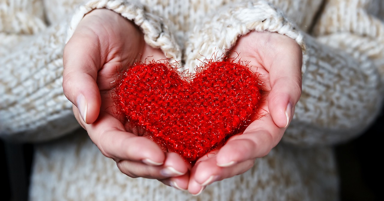 A woman holding a fabric heart, Why generosity is the ultimate form of worship