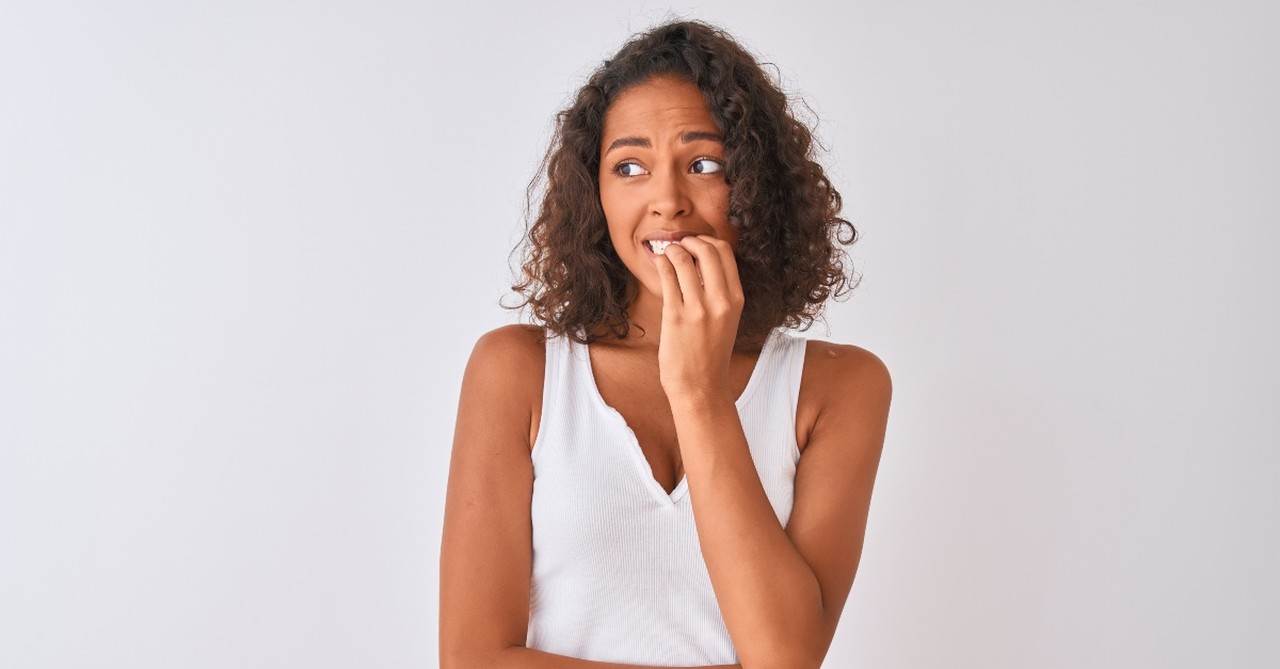 Nervous woman biting her nails