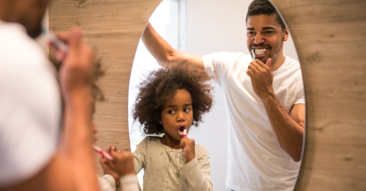 dad and daughter brushing teeth in mirror; what is the most popular father-daughter wedding song?