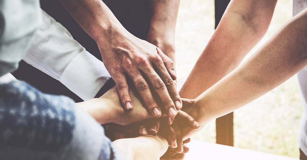 praying hands in a pile of unity, resist the devil