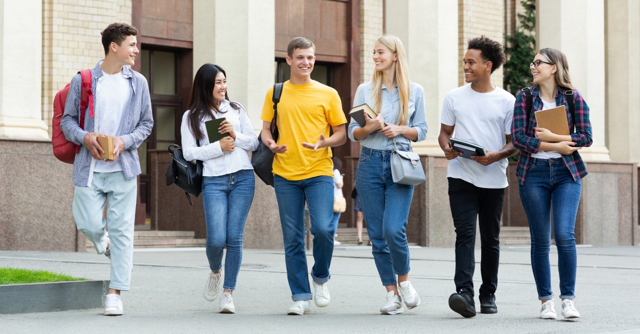 diverse group of college student friends walking together