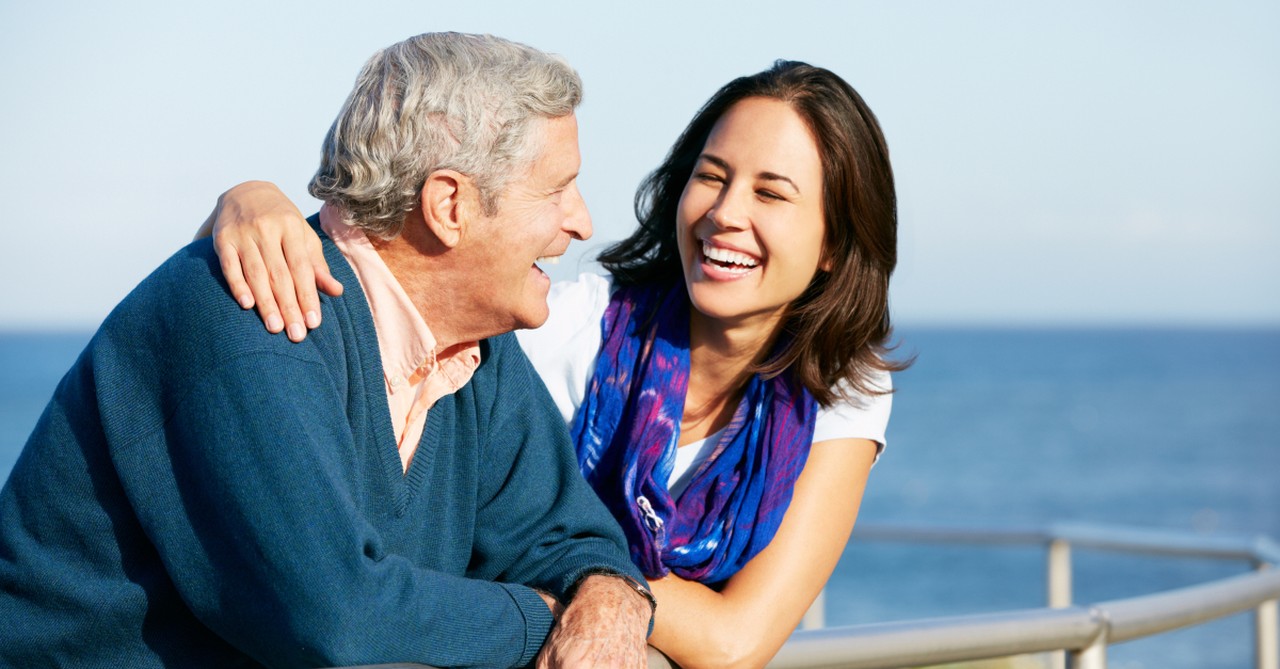 adult woman hugging dad at beach Fathers Day