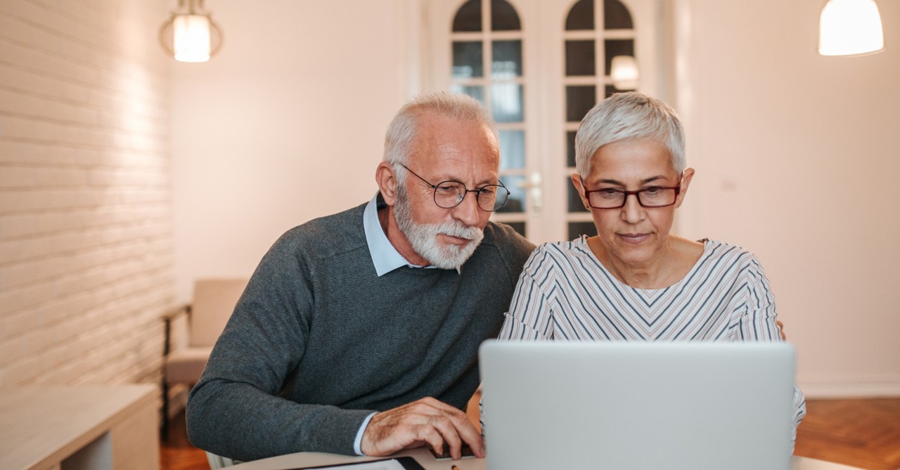 senior couple looking at laptop