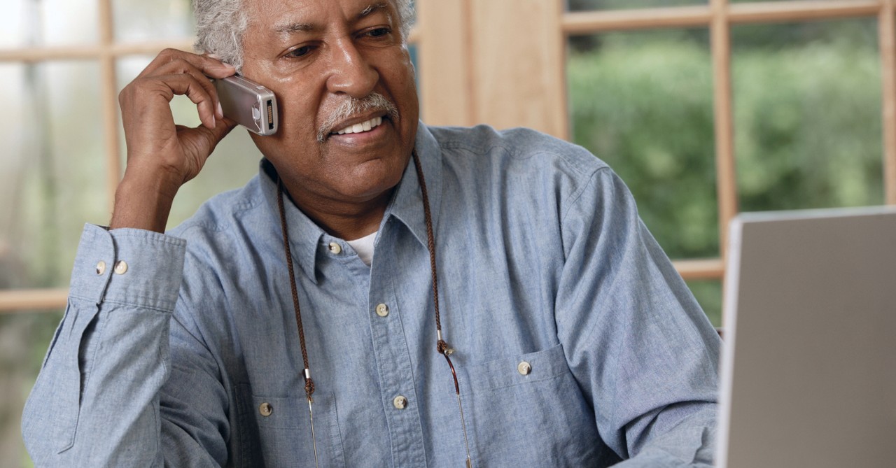 senior man on phone and laptop planning finances