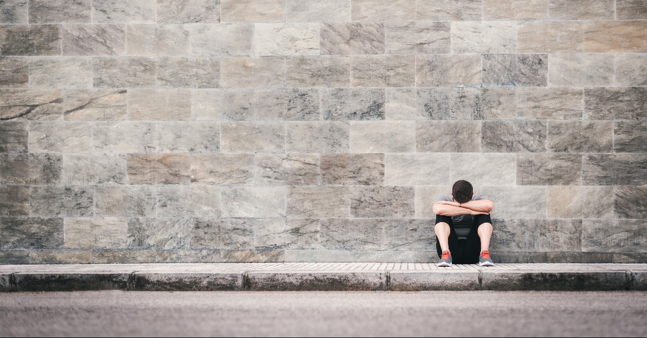 Man on the street with his head down