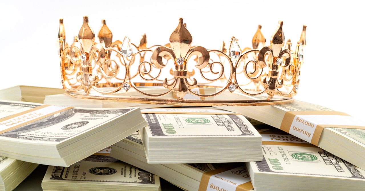 stacks of money with crown on top