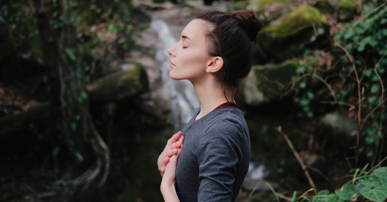 Peaceful woman outside, god shows up in our darkest hours