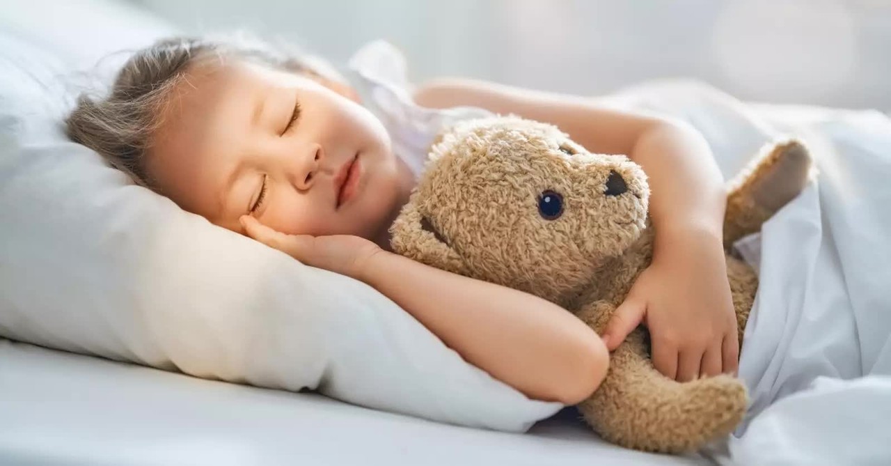 little girl sleeping peacefully in bed with teddy bear, now i lay me down to sleep