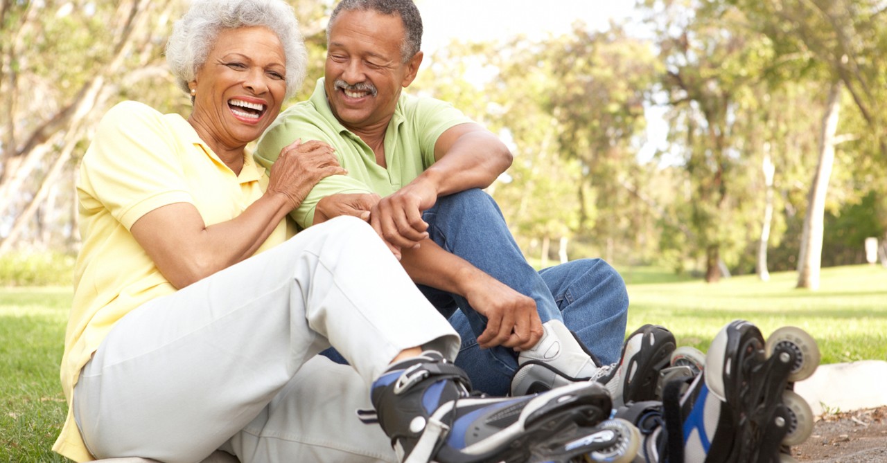 happy active senior couple rollerblades