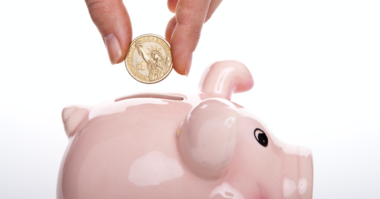 pink piggy bank and a coin