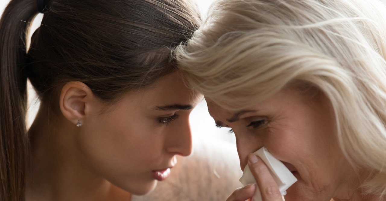 adult child comforting mom crying