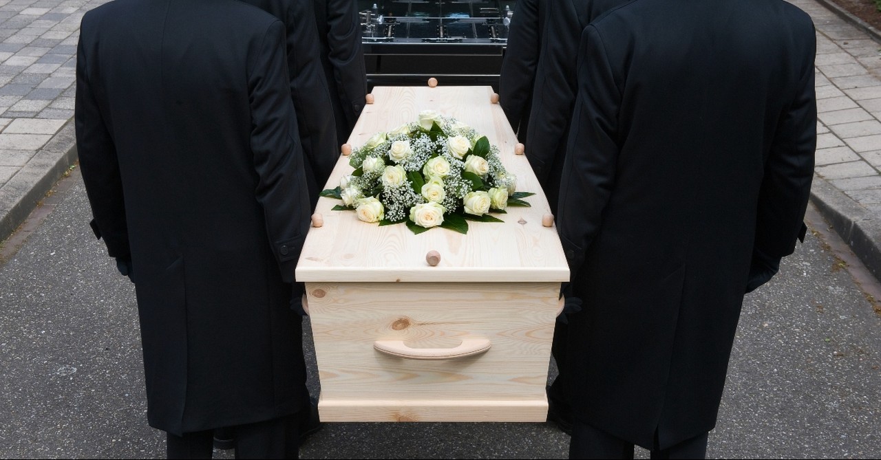 Ushers carrying a casket