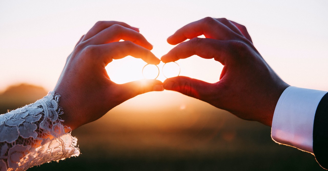 silhouette of wedding couple holding rings at sunset, prayers for marriage