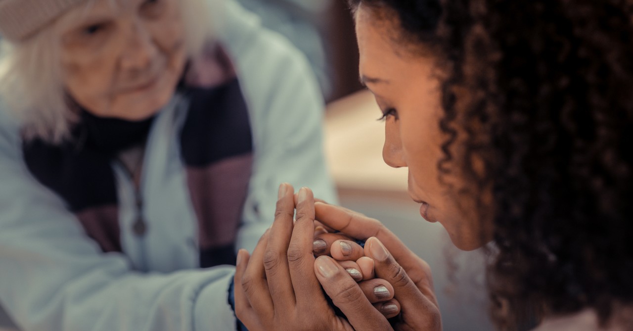 woman holding hands offering peace and love in injustice homelessness