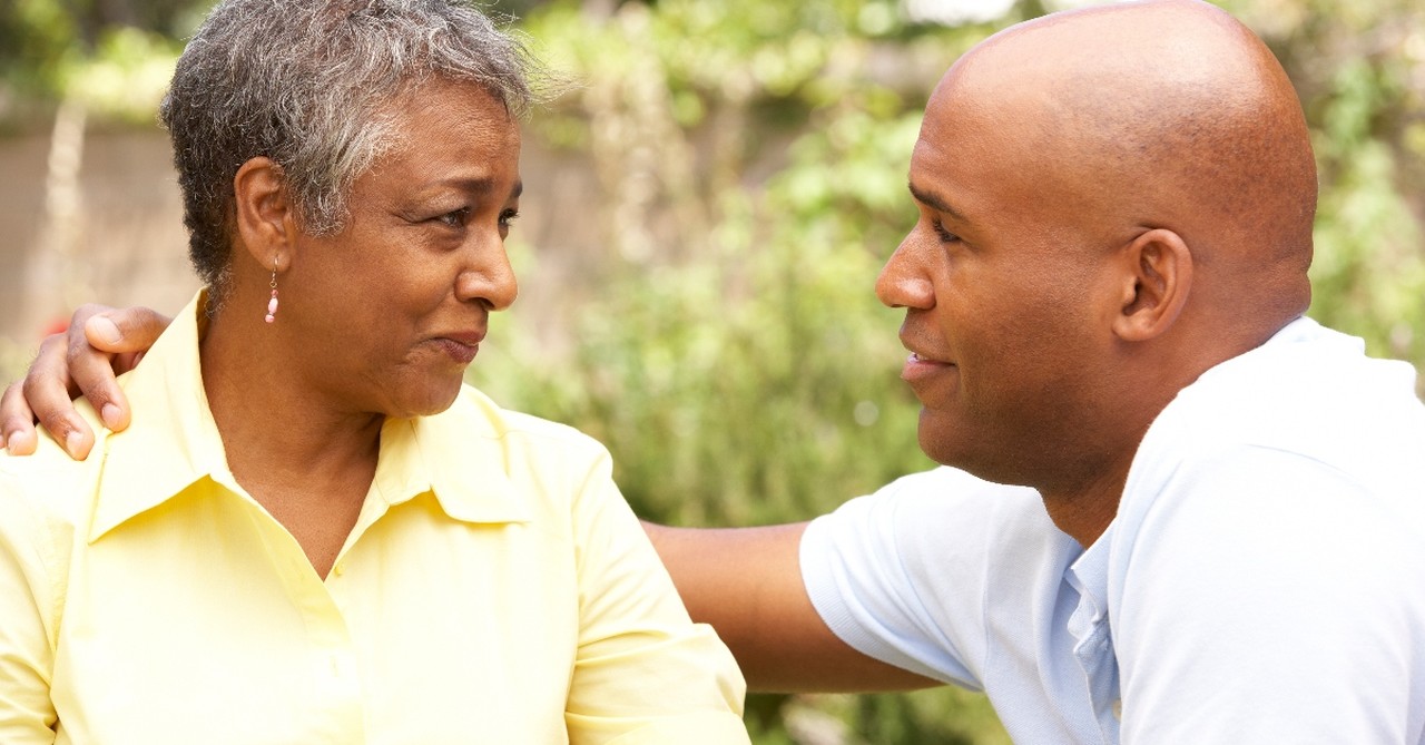 mom being comforted by adult son, empty nester